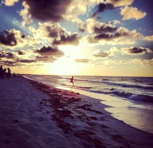 Scenic view of beach against sky during sunset