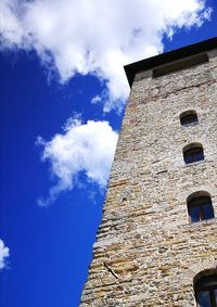 Low angle view of bell tower against blue sky