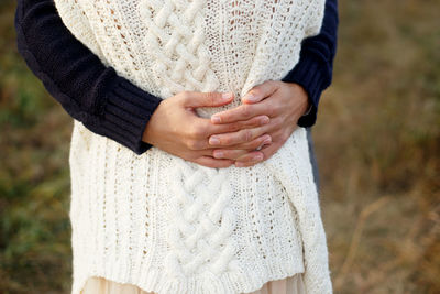 Midsection of woman standing against blurred background