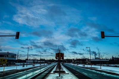 Railroad tracks against sky during winter