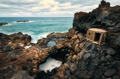 Volcanic rocky coastal scenery, fisherman's shelter and cave are charco del palo, lanzerote,canaries 