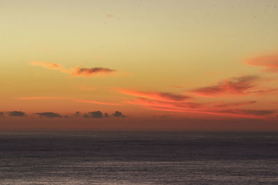 Scenic view of sea against romantic sky at sunset