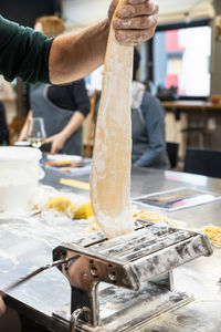 Cropped hand of man preparing food on table