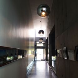Illuminated lights hanging in corridor