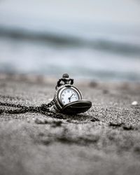 Close-up of pocket watch on surface