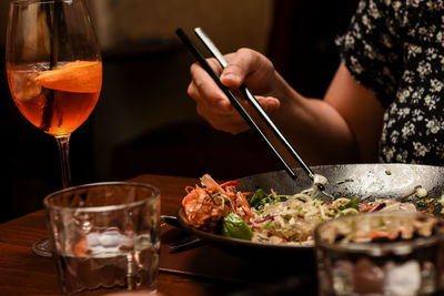 A woman eating with chopsticks