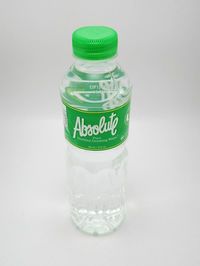 Close-up of glass bottle against white background