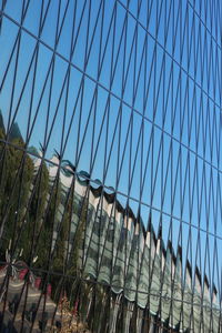 Low angle view of fence against blue sky