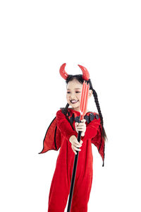 Woman holding red umbrella against white background