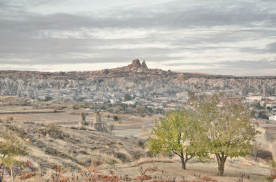 Panoramic view of arid mountains against cloud sky