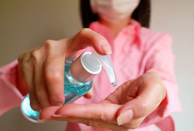 Close-up of woman holding pink hands