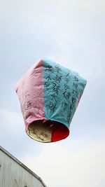 Low angle view of pink umbrella against sky