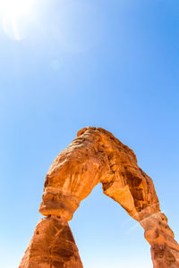 View of natural arch against clear sky during sunny day