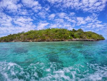 Scenic view of sea against cloudy sky