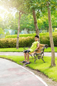 Side view of man sitting on street