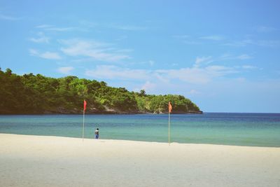 Scenic view of beach against blue sky