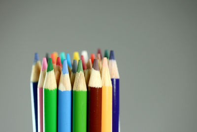 Close-up of colored pencils against white background