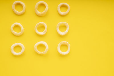 Directly above shot of candies on yellow background