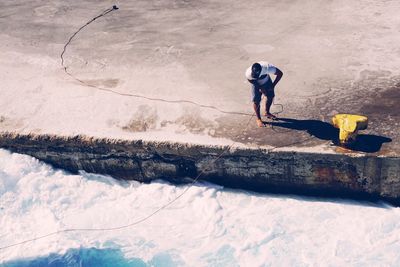 High angle view of man standing on pier