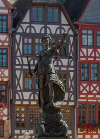 Low angle view of statue against building