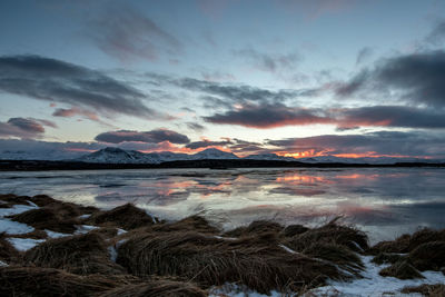 Scenic view of lake against sky during sunset
