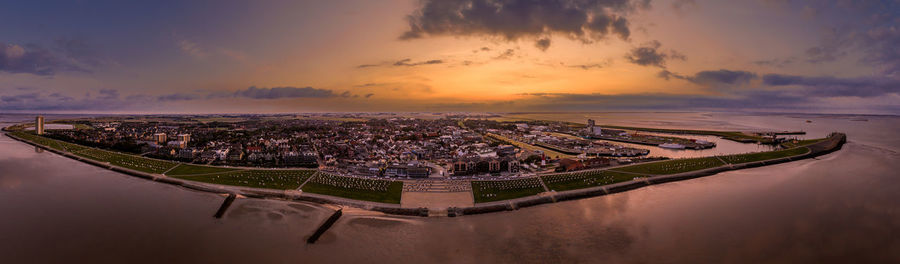 Aerial view of buildings in city during sunset