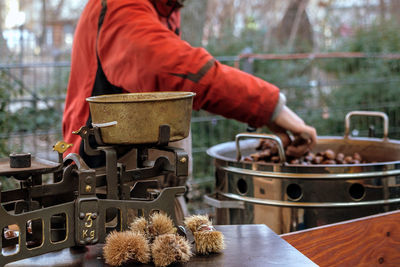 The chestnut seller roasts his goods at the market