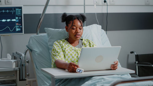 Young woman using laptop at home