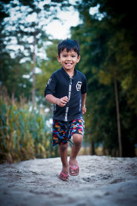 Portrait of smiling boy standing outdoors