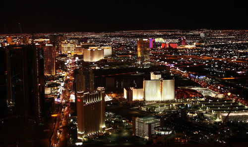 High angle view of illuminated city buildings at night