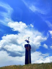 Tower on field against blue sky