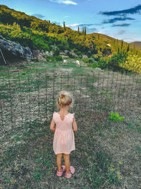 Full length of girl standing on grass