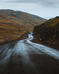 Scenic view of road by mountain against autumn sky in iceland 