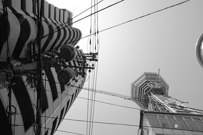 Low angle view of electricity pylon against sky