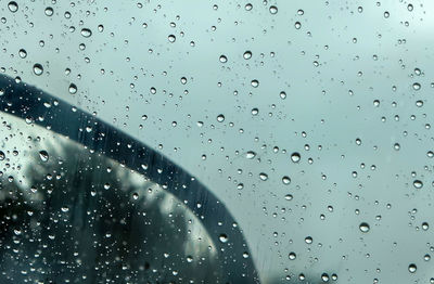 Full frame shot of wet glass window during rainy season