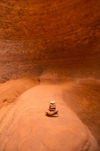 Close-up of old cross on rock