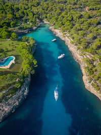 Aerial view of boats in beautiful sea bay, cala mitjana, mallorca, spain