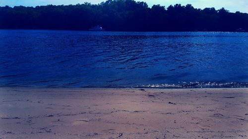 Scenic view of beach against blue sky