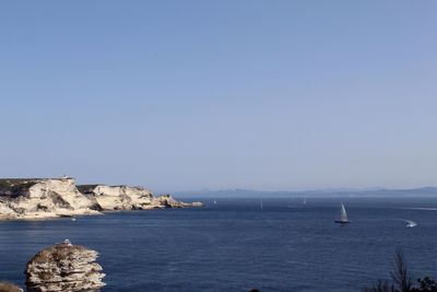 Scenic view of sea against clear blue sky