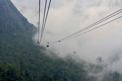 Overhead cable car against sky