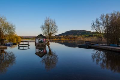 Scenic view of lake against clear blue sky