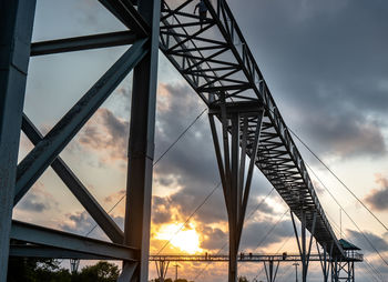 Low angle view of silhouette bridge against sky during sunset