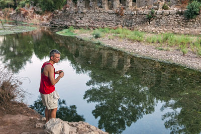 Man standing against lake