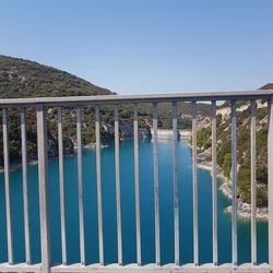 Bridge over water against clear blue sky