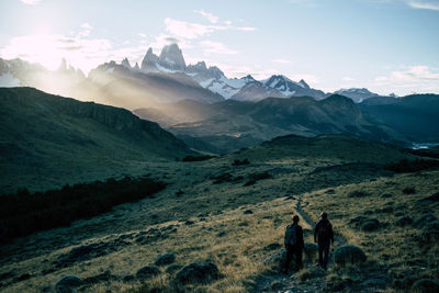 Scenic view of snowcapped mountain against sky and sunset