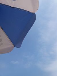 Low angle view of airplane flying against blue sky