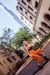 Low angle view of buildings against trees