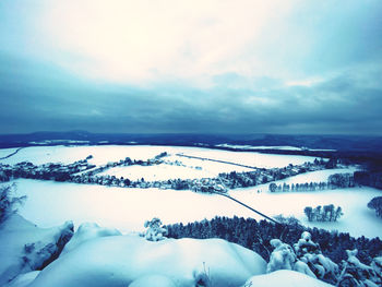 Snow covered landscape against sky