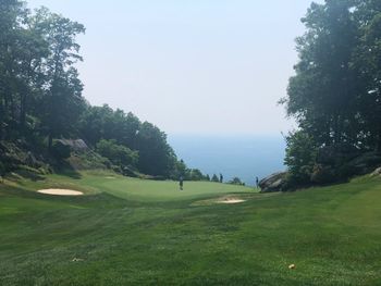 Scenic view of golf course against sky