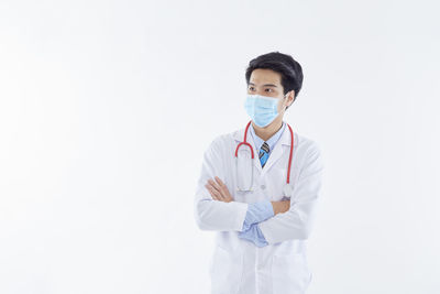 Portrait of man standing against white background